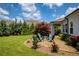 Well-manicured backyard features lush lawn, beautiful landscaping, and a cozy seating area at 4430 Alister Park Dr, Cumming, GA 30040