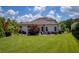 Grassy backyard with a patio and seating area featuring beautiful landscaping and perimeter fence at 4430 Alister Park Dr, Cumming, GA 30040