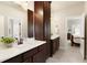 Modern bathroom with double sinks, dark wood cabinetry, and a walk-in closet at 4430 Alister Park Dr, Cumming, GA 30040