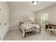Comfortable bedroom with a metal bed frame, a cozy chair, and plenty of storage at 4430 Alister Park Dr, Cumming, GA 30040