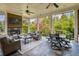 Relaxing covered patio boasts a fireplace, dining area and comfortable seating with natural light at 4430 Alister Park Dr, Cumming, GA 30040