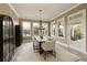 The dining room features a modern chandelier, elegant table setting and scenic views at 4430 Alister Park Dr, Cumming, GA 30040