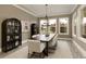 Dining room features a dark wood table and chairs and modern decorative cabinets at 4430 Alister Park Dr, Cumming, GA 30040