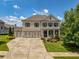 Beautiful brick home features a three-car garage and a well-manicured front yard, all under a bright, sunny sky at 4430 Alister Park Dr, Cumming, GA 30040