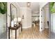 Elegant foyer with a decorative mirror, stylish lighting, and hardwood floors leading into the home at 4430 Alister Park Dr, Cumming, GA 30040