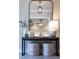 Foyer features console table with decorative vases, soft lighting, and upholstered stools for a stylish entry at 4430 Alister Park Dr, Cumming, GA 30040