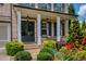 Inviting front entrance with a covered porch, well-maintained landscaping, and clear property number signage at 4430 Alister Park Dr, Cumming, GA 30040