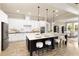 Modern kitchen features stainless appliances, granite countertops, and an island with seating at 4430 Alister Park Dr, Cumming, GA 30040