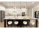 Open concept kitchen with a large island, white cabinets, pendant lights, and seating at 4430 Alister Park Dr, Cumming, GA 30040