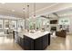 Open floor plan with island, fireplace, and dining area filled with natural light at 4430 Alister Park Dr, Cumming, GA 30040