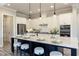 Bright kitchen features white cabinets, black hardware, stainless appliances, and seating around center island at 4430 Alister Park Dr, Cumming, GA 30040