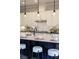 Bright kitchen with white cabinetry, granite countertops, and an island with stool seating at 4430 Alister Park Dr, Cumming, GA 30040