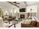 Cozy living room showcasing a fireplace, built-in shelves, ceiling fan, and comfortable seating at 4430 Alister Park Dr, Cumming, GA 30040