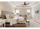 This is a staged main bedroom with a carpet, furniture, and a ceiling fan at 4430 Alister Park Dr, Cumming, GA 30040