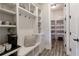 Mudroom with built in seating, storage, and access to a walk-in pantry with shelving at 4430 Alister Park Dr, Cumming, GA 30040