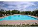 Clean community pool with chairs and umbrellas available at 4430 Alister Park Dr, Cumming, GA 30040