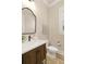 Chic powder room with a dark wood vanity, stylish mirror, and modern fixtures, perfect for guests at 4430 Alister Park Dr, Cumming, GA 30040
