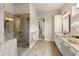 A glass-enclosed tile shower with rainfall shower head and modern fixtures at 4430 Alister Park Dr, Cumming, GA 30040