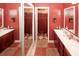 Spacious bathroom featuring double sinks, large mirrors, and decorative tile flooring and a shower with curtain at 1030 Chapman Ln, Stone Mountain, GA 30088