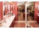 Bathroom with double vanity and mirrored closet doors leading to living area and bedroom at 1030 Chapman Ln, Stone Mountain, GA 30088