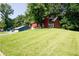 Charming home featuring a chimney and a large green lawn on a hill at 1030 Chapman Ln, Stone Mountain, GA 30088