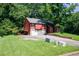 Exterior shot shows a two-car garage, a carport, and stone accents at 1030 Chapman Ln, Stone Mountain, GA 30088