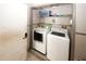 Laundry room with side by side washer and dryer hookups and shelving above at 1030 Chapman Ln, Stone Mountain, GA 30088