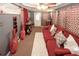 A modern living room, featuring a comfortable sofa and stylish decor with lots of red hues at 1030 Chapman Ln, Stone Mountain, GA 30088