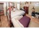 The primary bedroom has a four-poster bed, wood floors, a seating area, and two closets at 1030 Chapman Ln, Stone Mountain, GA 30088