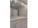 Bathroom featuring white dual sinks with quartz countertop, contemporary mirror and lighting at 1976 Deco Dr, Kennesaw, GA 30144