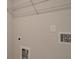 A utilitarian laundry room showing washing machine hook ups and a wire rack shelf at 1976 Deco Dr, Kennesaw, GA 30144