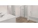 Bright bathroom features a double vanity, walk-in shower, and soaking tub at 205 Silver Moon Dr, Loganville, GA 30052