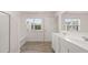 Bright bathroom with double sink vanity, shower, and window overlooking the backyard at 205 Silver Moon Dr, Loganville, GA 30052