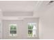 Bedroom with a tray ceiling, recessed lighting, and lots of light from two windows at 205 Silver Moon Dr, Loganville, GA 30052