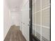 Bright hallway with wood floors and white doors with black hardware, providing a clean and modern aesthetic at 205 Silver Moon Dr, Loganville, GA 30052