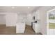 Modern kitchen with white cabinetry, stainless steel appliances, a center island, and hardwood floors at 205 Silver Moon Dr, Loganville, GA 30052
