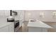 Open-concept kitchen features a spacious island, stainless steel appliances, and hardwood floors at 205 Silver Moon Dr, Loganville, GA 30052
