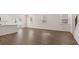 Open concept living space with wood floors, lots of light from patio doors and windows, and white trim at 205 Silver Moon Dr, Loganville, GA 30052