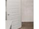 Bright pantry featuring wire shelving, painted white door, and dark-stained wood floors at 205 Silver Moon Dr, Loganville, GA 30052
