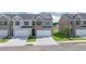 Charming townhome exteriors with brick and gray siding, featuring attached garages and well-maintained landscaping at 205 Silver Moon Dr, Loganville, GA 30052