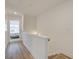 Upstairs hallway leading to the bedrooms, showcasing hardwood floors and neutral decor at 1983 Deco Dr, Kennesaw, GA 30144