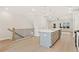 Open-concept living space with hardwood floors, rod iron staircase, and views to the kitchen at 1987 Deco Dr, Kennesaw, GA 30144