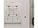 Bathroom with a double vanity, large mirror with modern lighting, and glass shower at 1995 Deco Dr, Kennesaw, GA 30144