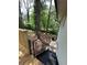 Backyard view from the deck featuring mature trees, a walkway, and black stairs to the house at 2764 Ocean Valley Dr, Atlanta, GA 30349