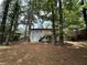 Exterior view of a backyard with mature trees, showing a new white deck on the back of the house at 2764 Ocean Valley Dr, Atlanta, GA 30349