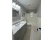 Updated bathroom with new vanity, quartz counters, tile flooring, tub and modern fixtures at 2764 Ocean Valley Dr, Atlanta, GA 30349