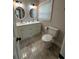 Bright bathroom featuring dual sinks, modern fixtures, updated flooring, and natural light at 2764 Ocean Valley Dr, Atlanta, GA 30349