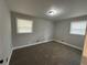 Carpeted bedroom with neutral walls and two windows, offering great natural light at 2764 Ocean Valley Dr, Atlanta, GA 30349