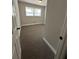 Cozy carpeted bedroom with fresh paint and natural light from a single window at 2764 Ocean Valley Dr, Atlanta, GA 30349