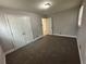 Carpeted bedroom with natural light from window, neutral walls and closet space at 2764 Ocean Valley Dr, Atlanta, GA 30349